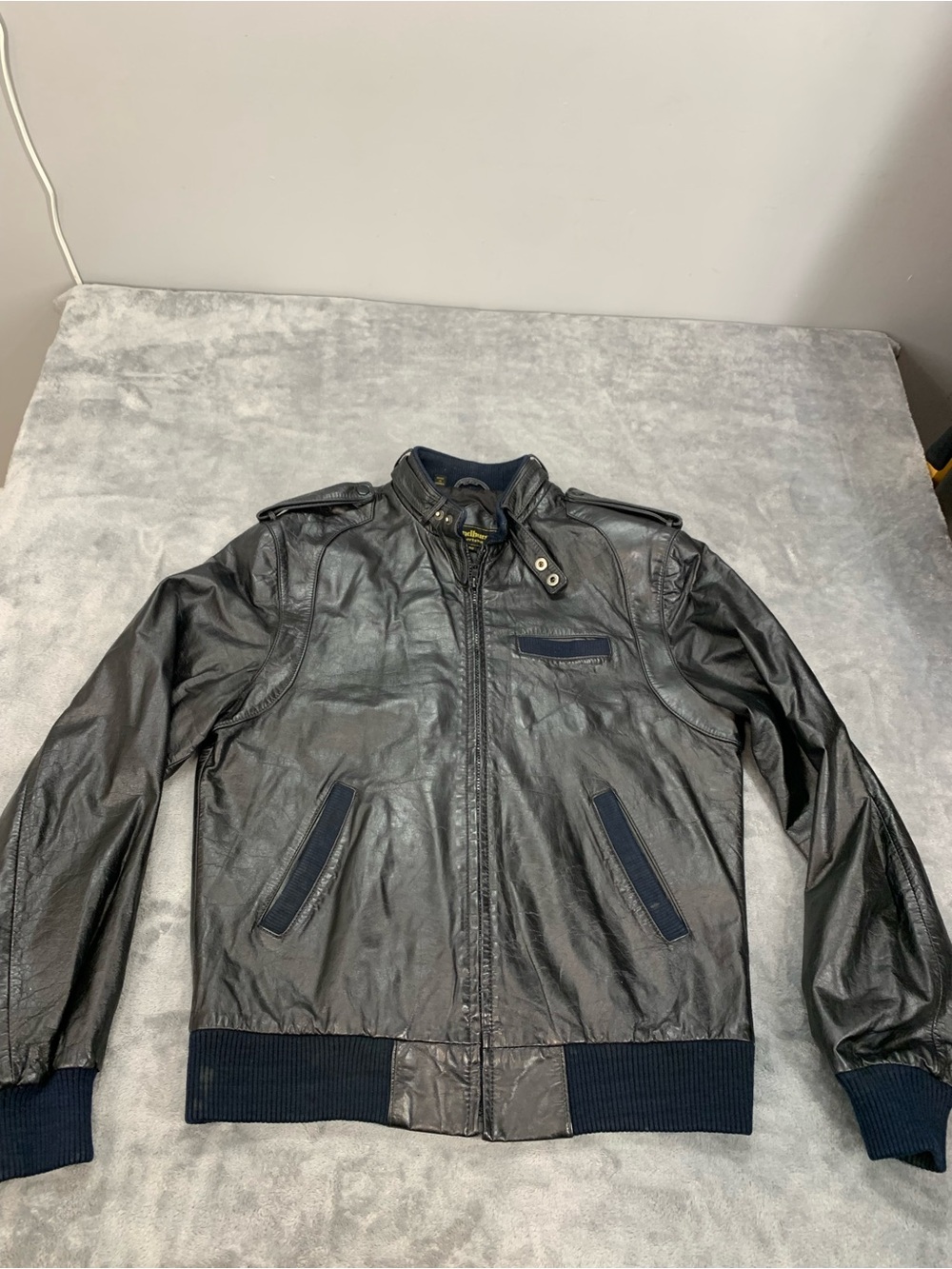 Andhurst Sportswear Black Leather Bomber Jacket with Navy Blue Ribbed Trim
Size: